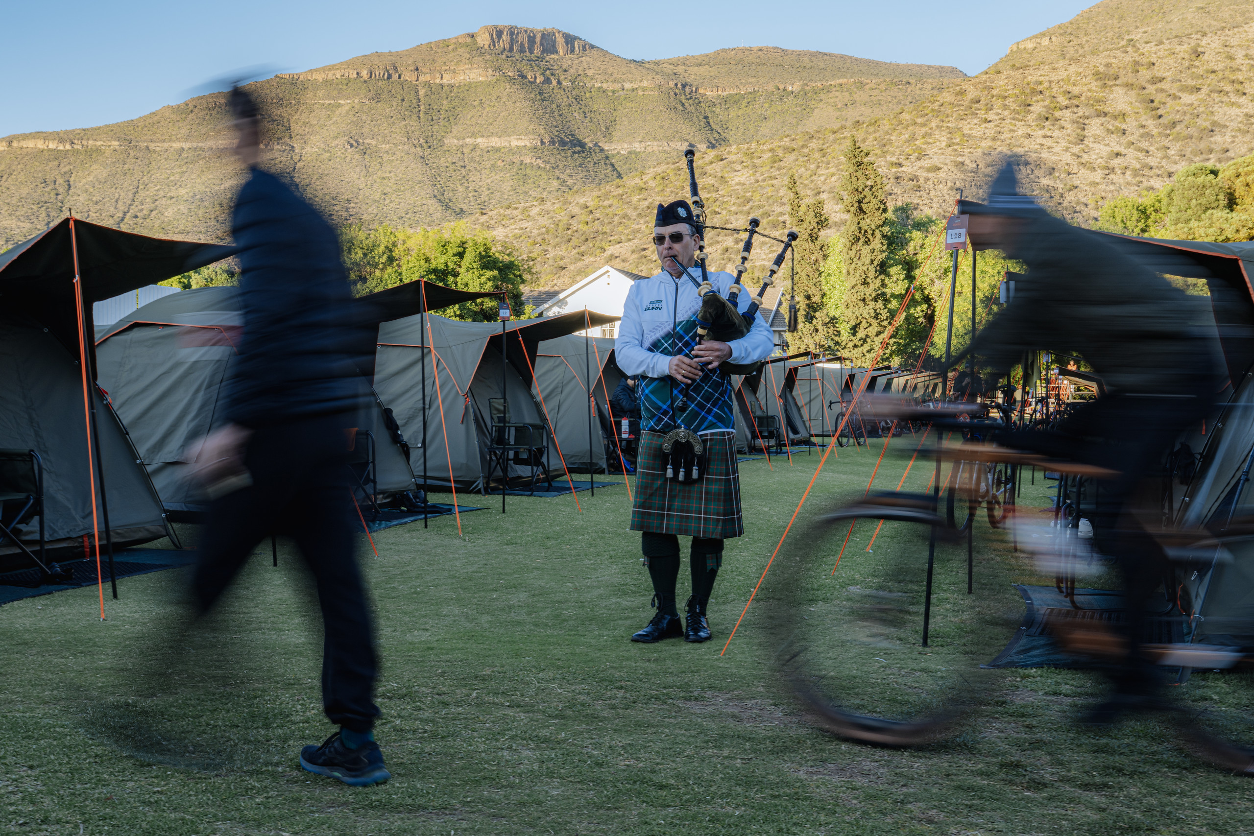 A piper walks through the Burn Camp on the Union High School sports field, Graaff-Reinet. Photo by Paul Ganse/Gravel Burn